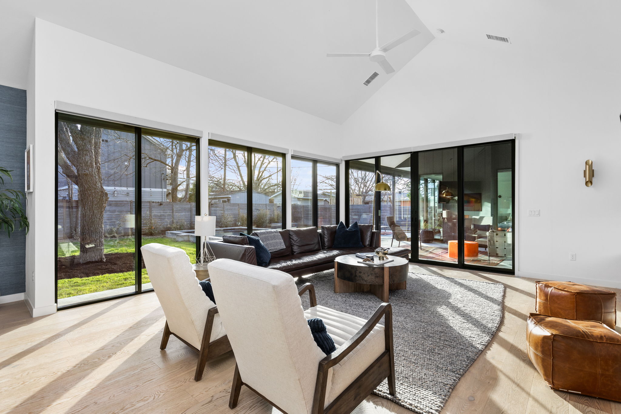 7502 St Louis Street Austin, TX 78757 - Photo 9 of 38 Sunroom / solarium with vaulted ceiling, plenty of natural light, and wood finished floors