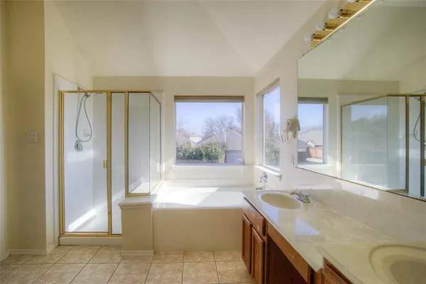 an empty room with a large window and a chandelier