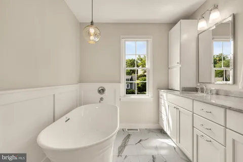 a bathroom with double vanity sinks and a mirror