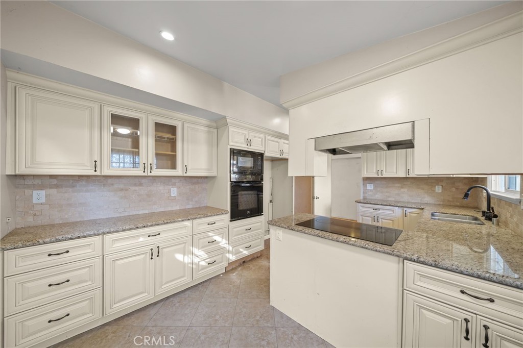 27151 Pembina Road Rancho Palos Verdes, CA 90275 - Photo 14 of 33 a kitchen with granite countertop a sink and cabinets