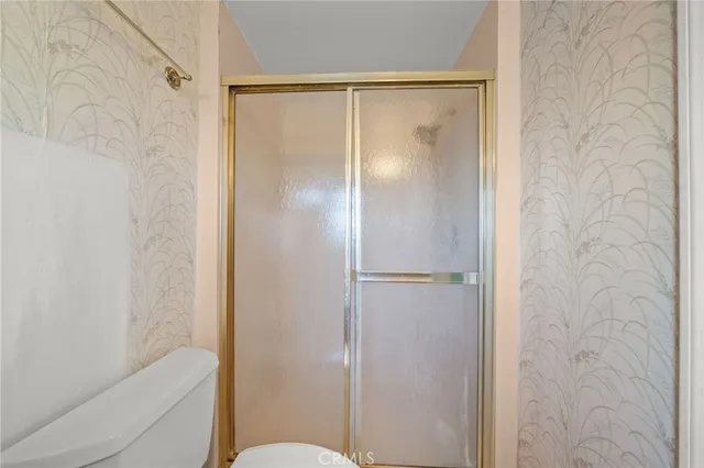 a bathroom with a shower and a toilet