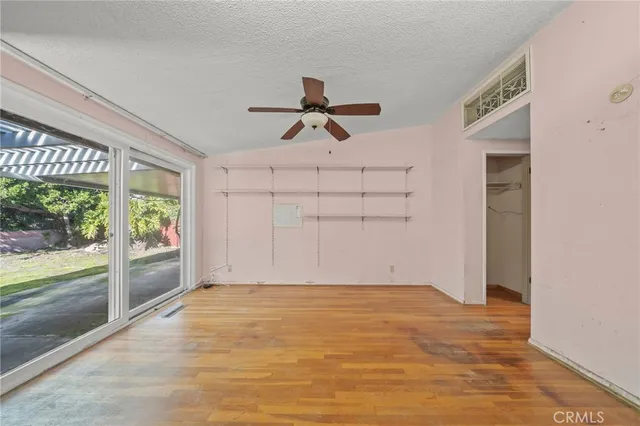 a view of a livingroom with a ceiling fan and window