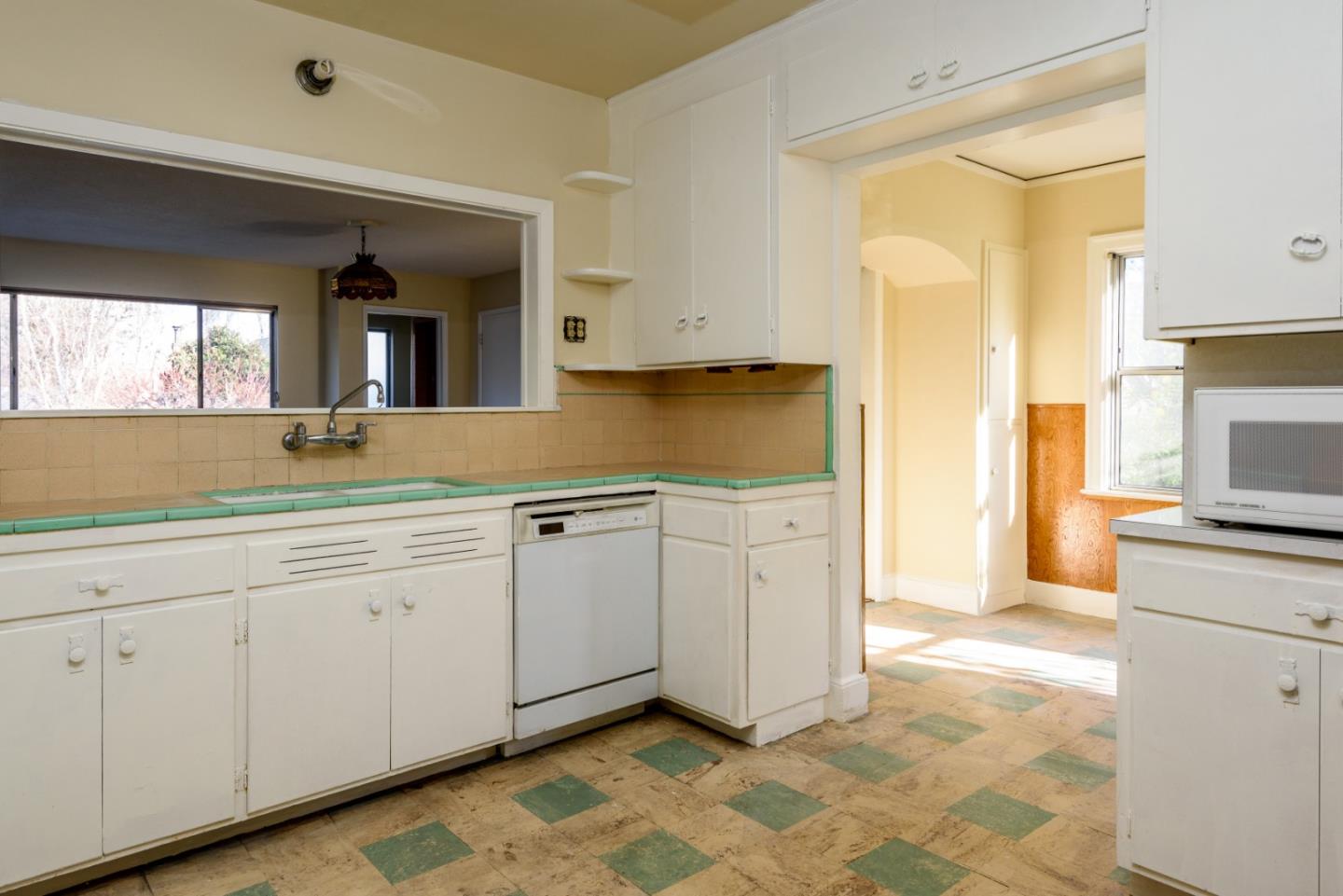 34 Dwight Road Burlingame, CA 94010 - Photo 4 of 13 a kitchen with granite countertop white cabinets and white appliances
