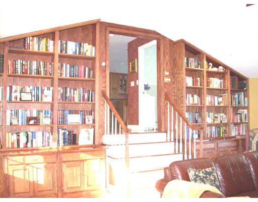 23 Deborah Road Hanover, MA 02339 - Photo 13 of 28 a view of a living room furniture and a book shelf