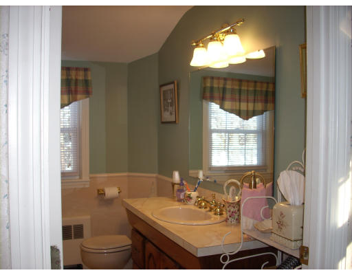23 Deborah Road Hanover, MA 02339 - Photo 24 of 28 a bathroom with a sink and a mirror