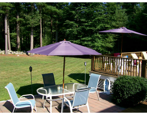 23 Deborah Road Hanover, MA 02339 - Photo 28 of 28 a view of a patio with furniture and table under an umbrella
