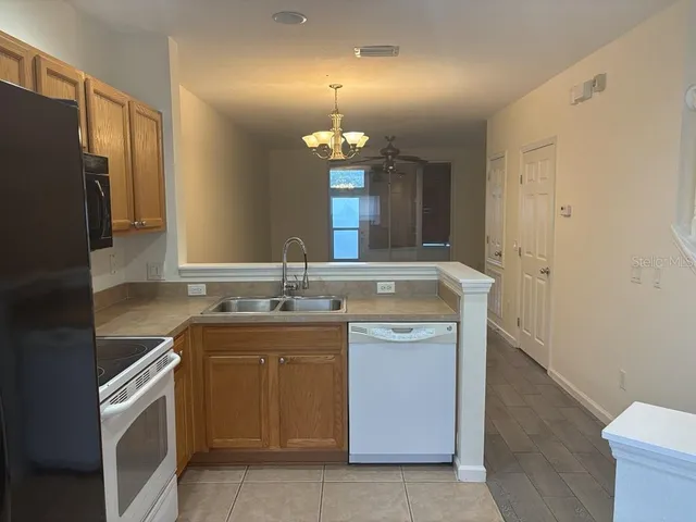 a kitchen with a sink stove and refrigerator