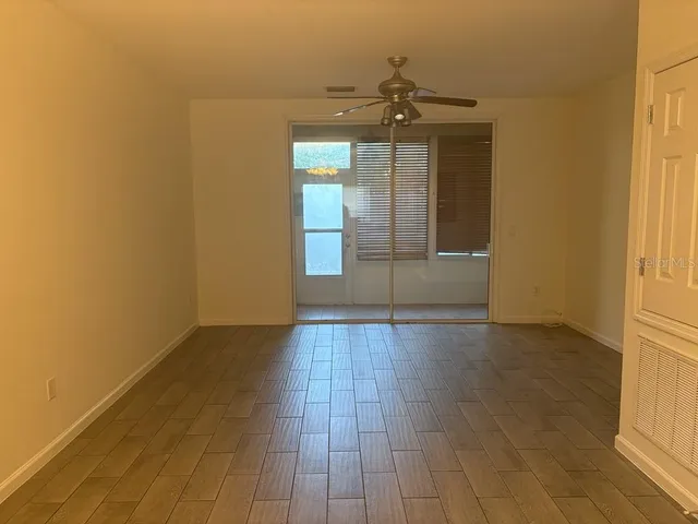 a view of a room with wooden floor