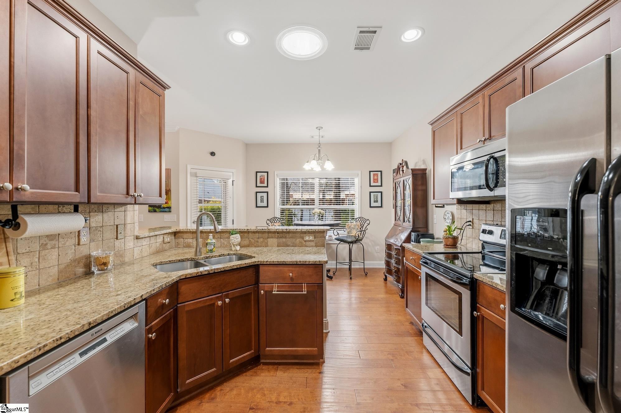 137 Prescott Drive Anderson, SC 29621 - Photo 13 of 31 Kitchen with views into breakfast room. All cabinets have pull out shelving. Fridge stays. Granite counters and pantry closet.