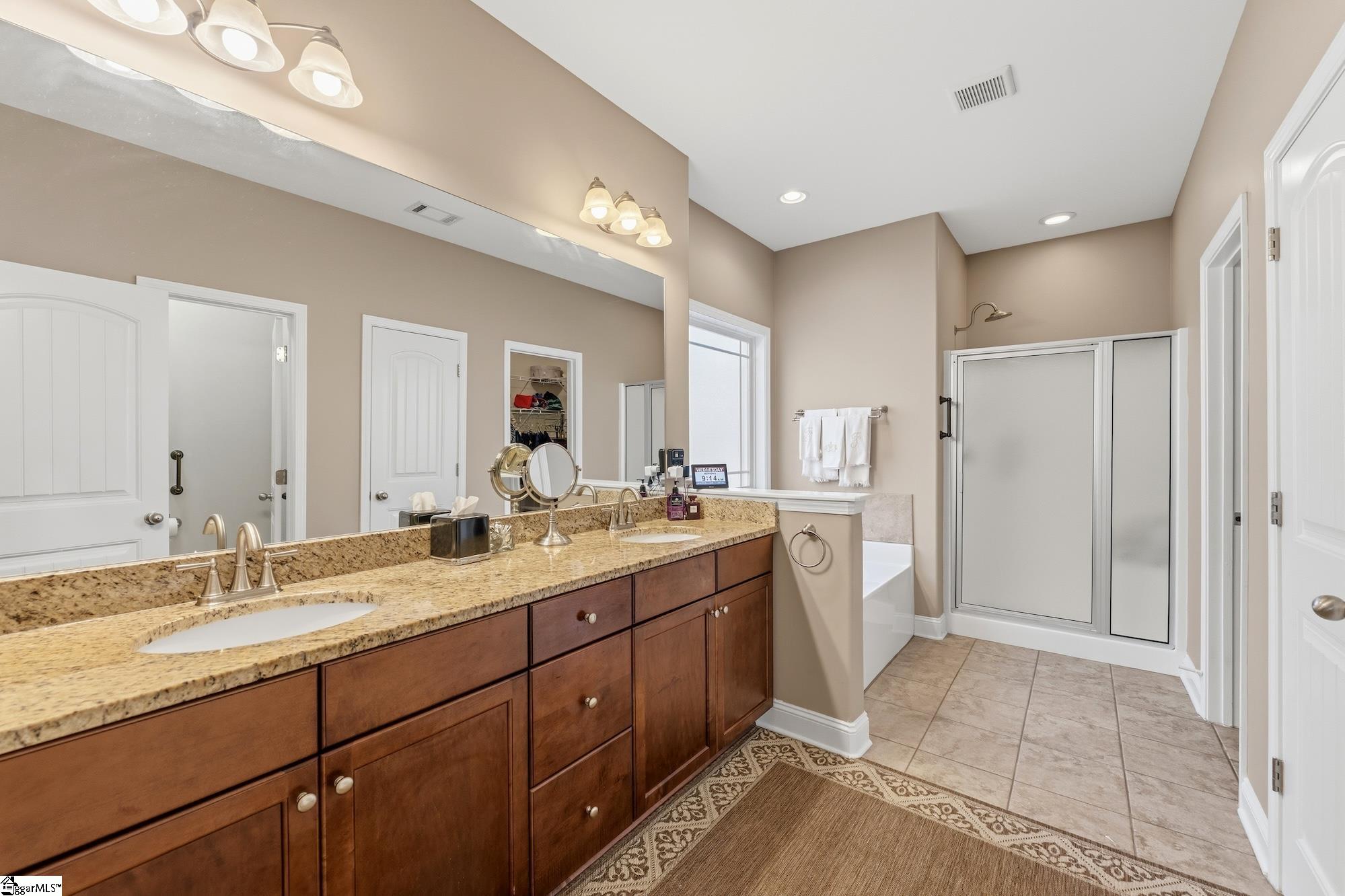 137 Prescott Drive Anderson, SC 29621 - Photo 19 of 31 Double sink, granite counters, tile flooring, walk-in shower, garden tub and walk-in closet.