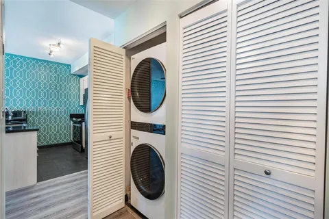 a view of a hallway with washer and dryer