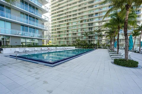 a view of swimming pool with outdoor seating and plants