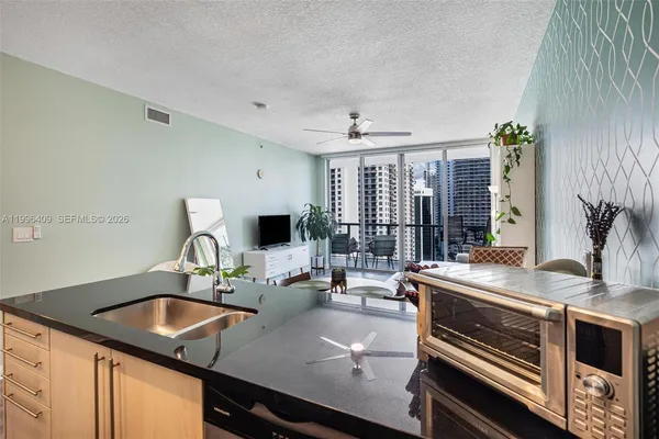 a kitchen with a sink appliances and a counter top space