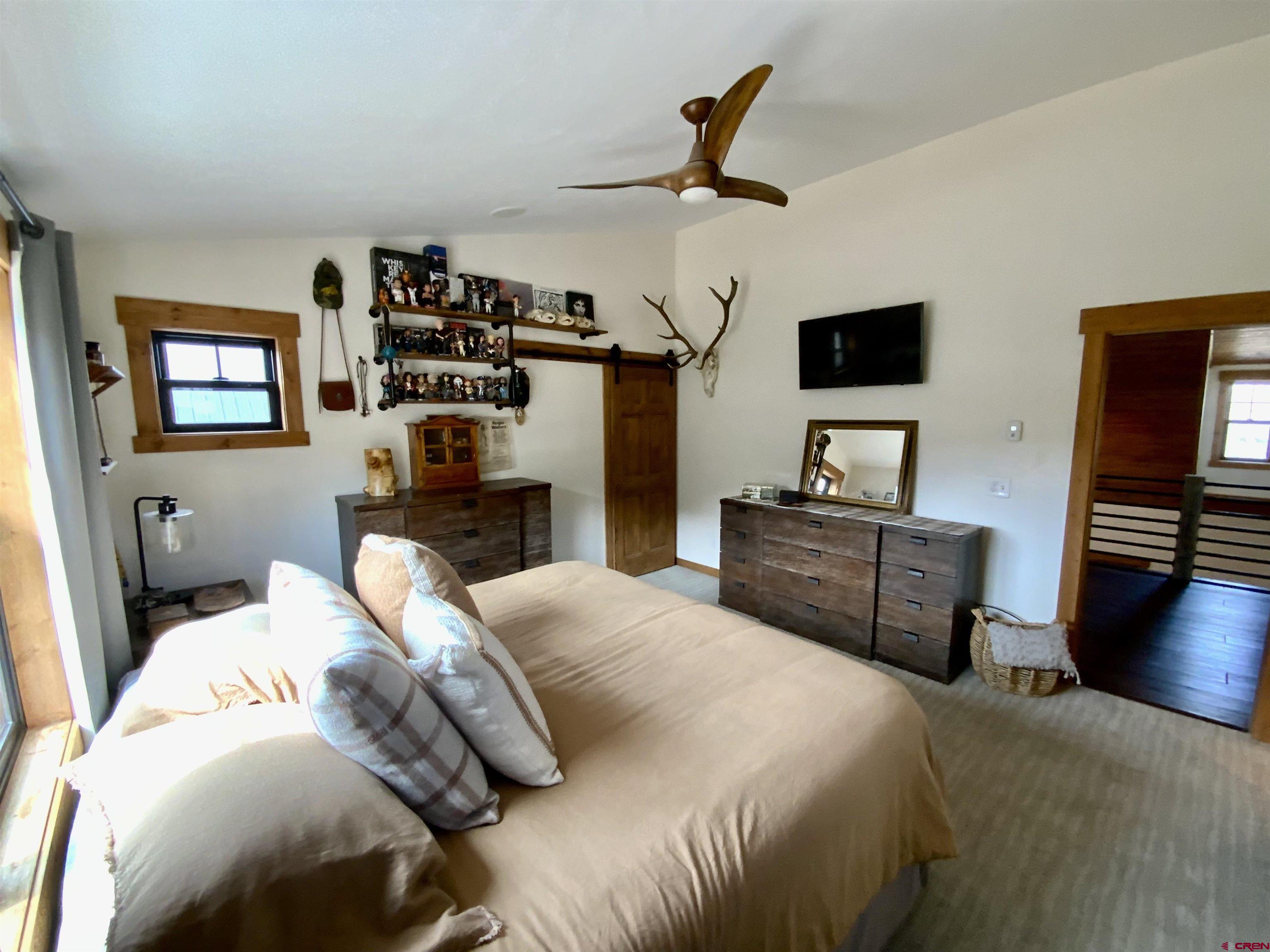 31876 State Highway Gunnison, CO 81230 - Photo 11 of 28 a bedroom with a bed a couch and dresser