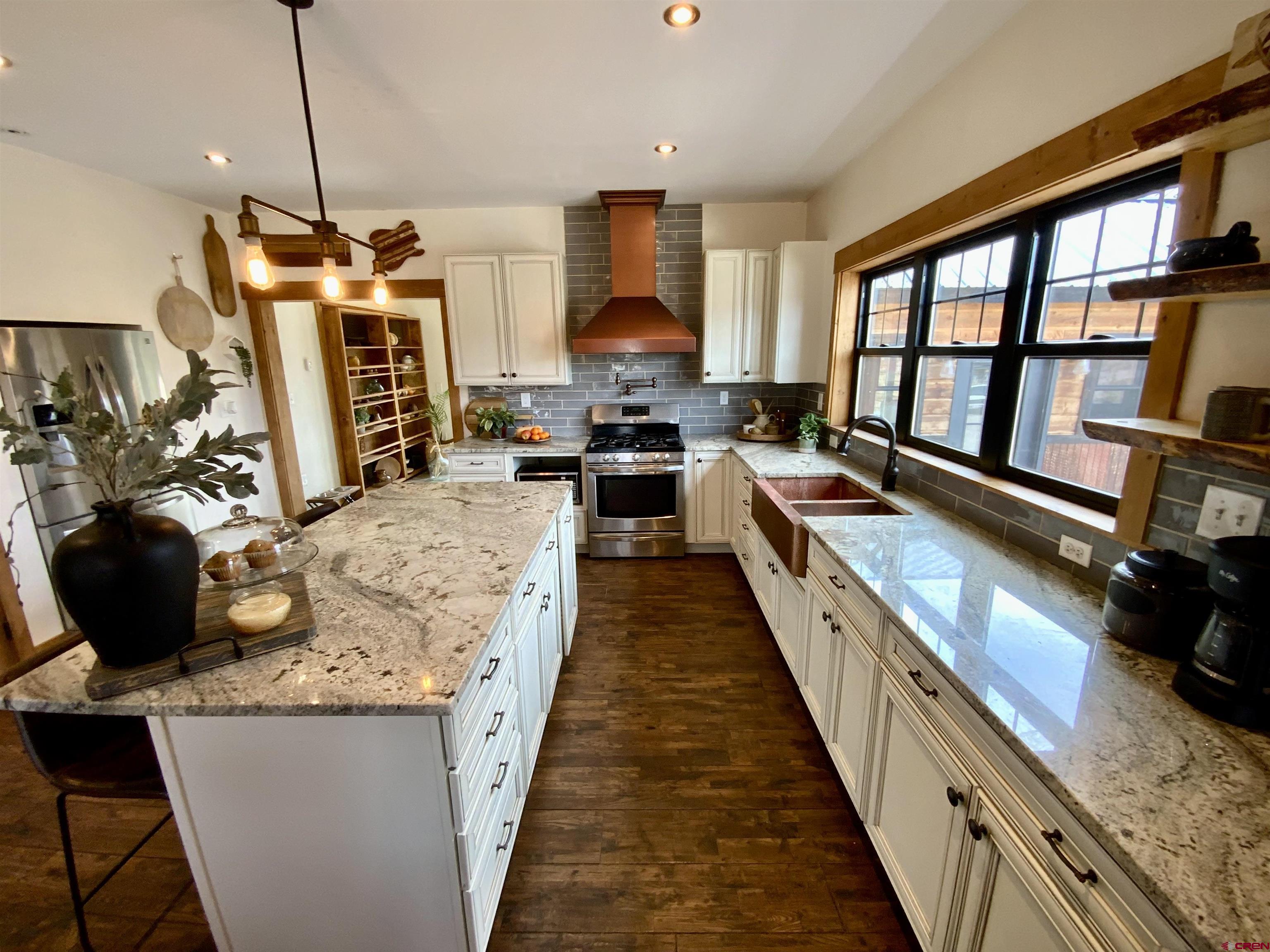 31876 State Highway Gunnison, CO 81230 - Photo 7 of 28 a kitchen with granite countertop a stove and a wooden floors