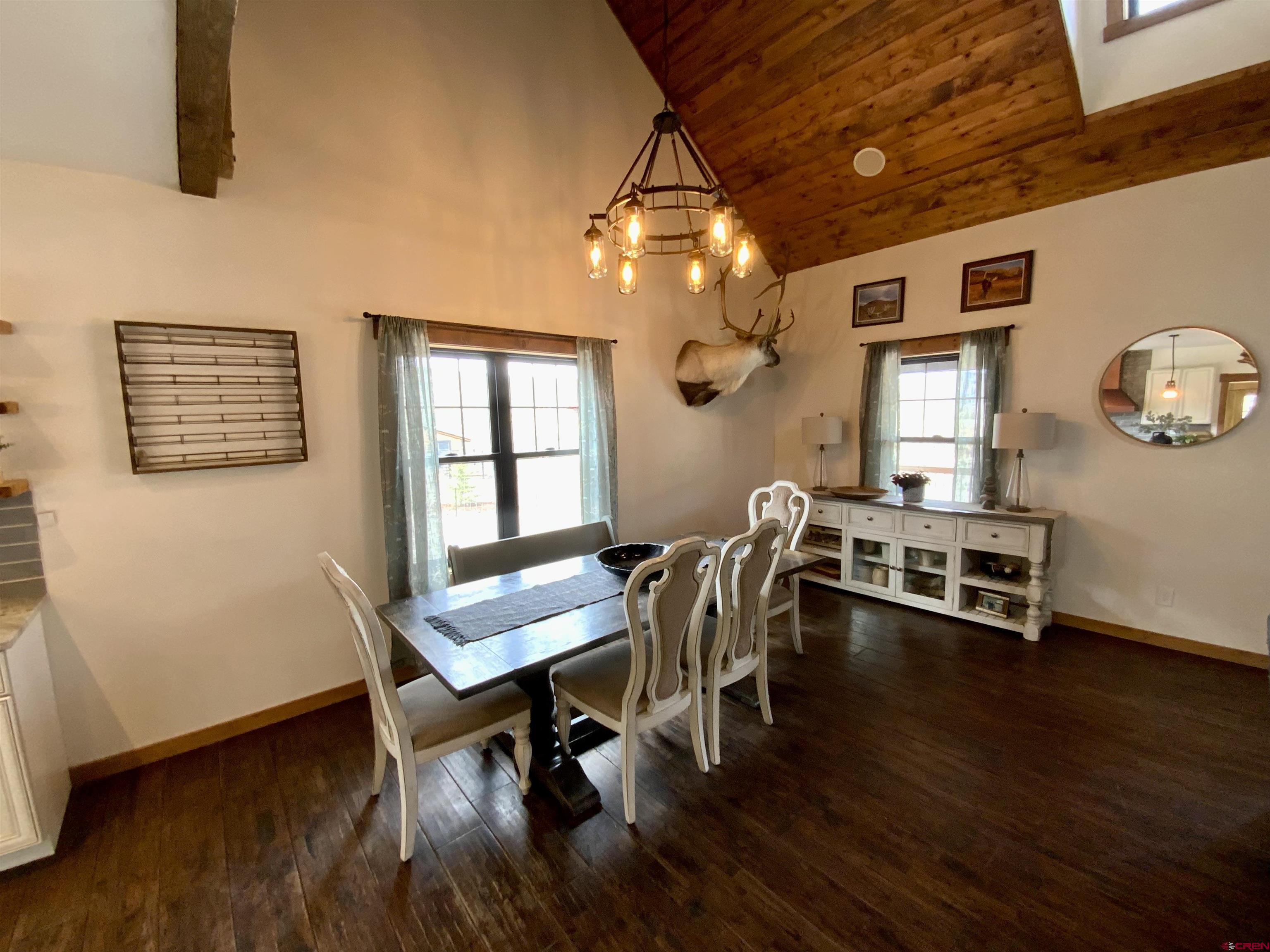 31876 State Highway Gunnison, CO 81230 - Photo 9 of 28 a view of a dining room with furniture a chandelier and wooden floor