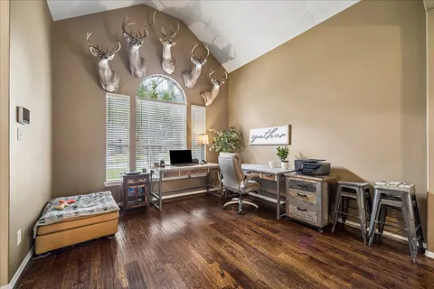 a living room with furniture and wooden floor