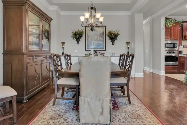 a view of a dining room with furniture and wooden floor