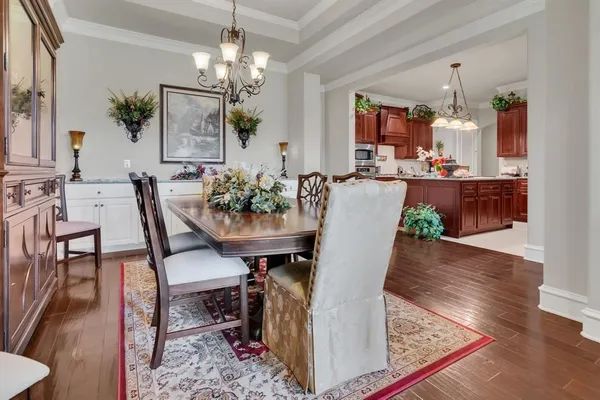 a view of a dining room with furniture and chandelier
