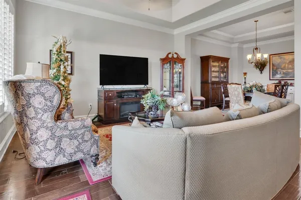 a living room with furniture a flat screen tv and a fireplace