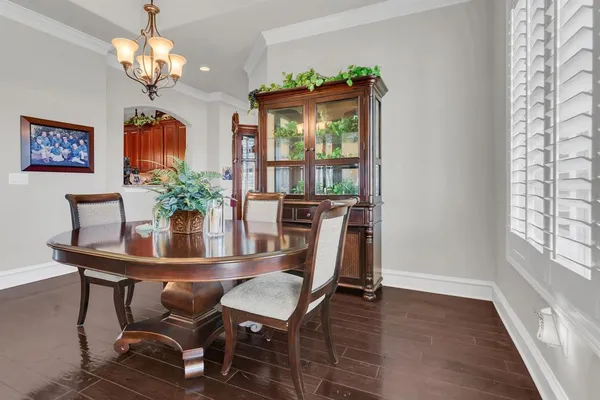 a view of a dining room with furniture wooden floor and chandelier