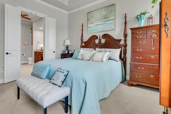 a bedroom with a bed and a painting on the wall