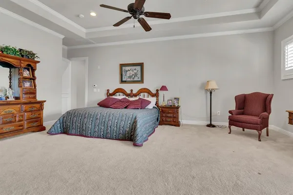 a bedroom with a bed and a couch