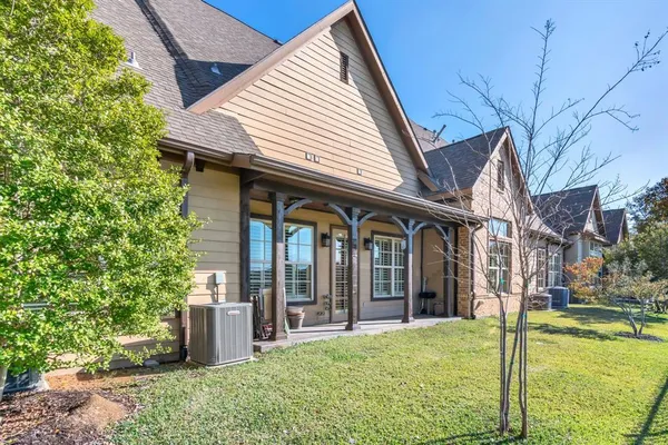 a view of a house with backyard porch and sitting area