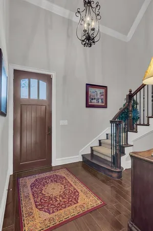 a view of entryway and hall with wooden floor