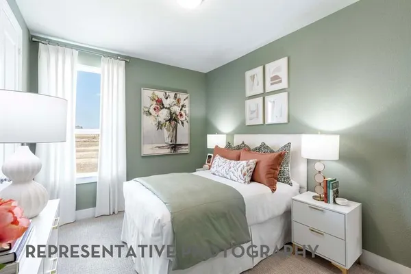 a bedroom with a large bed and a window