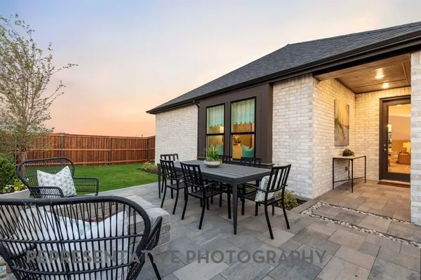 a view of a patio with a table and chairs