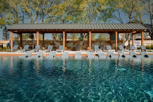 a swimming pool with outdoor seating and yard