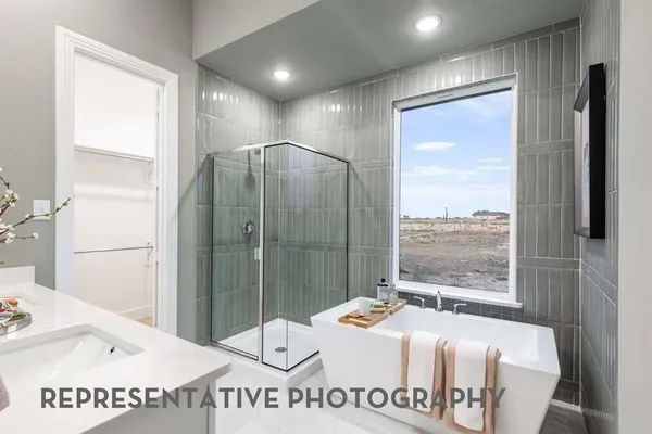 a en suite bathroom with a granite countertop sink and a mirror