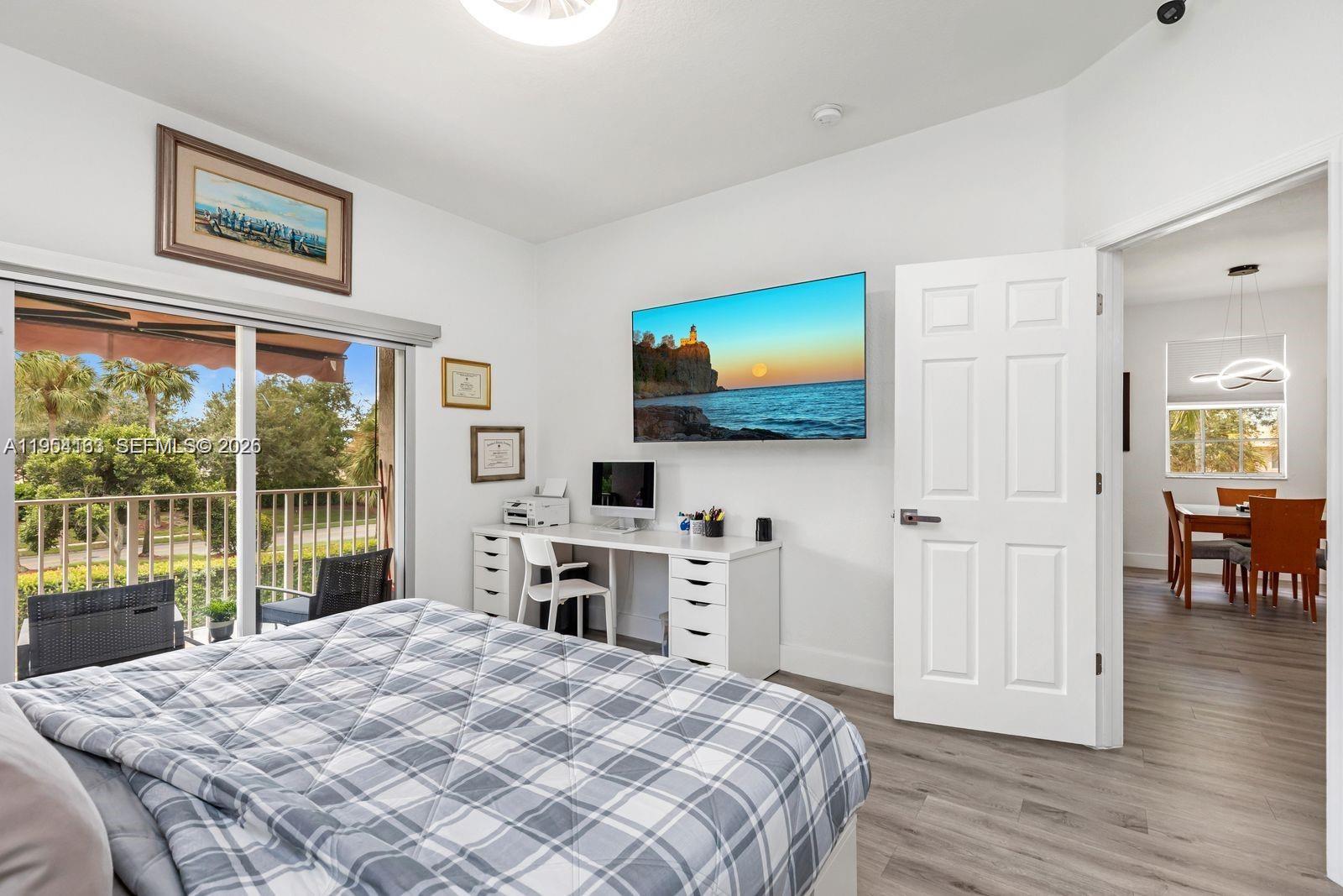 13216 Southwest 44th Street, Unit 11204 Miramar, FL 33027 - Photo 22 of 47 a bedroom with a bed and a flat screen tv