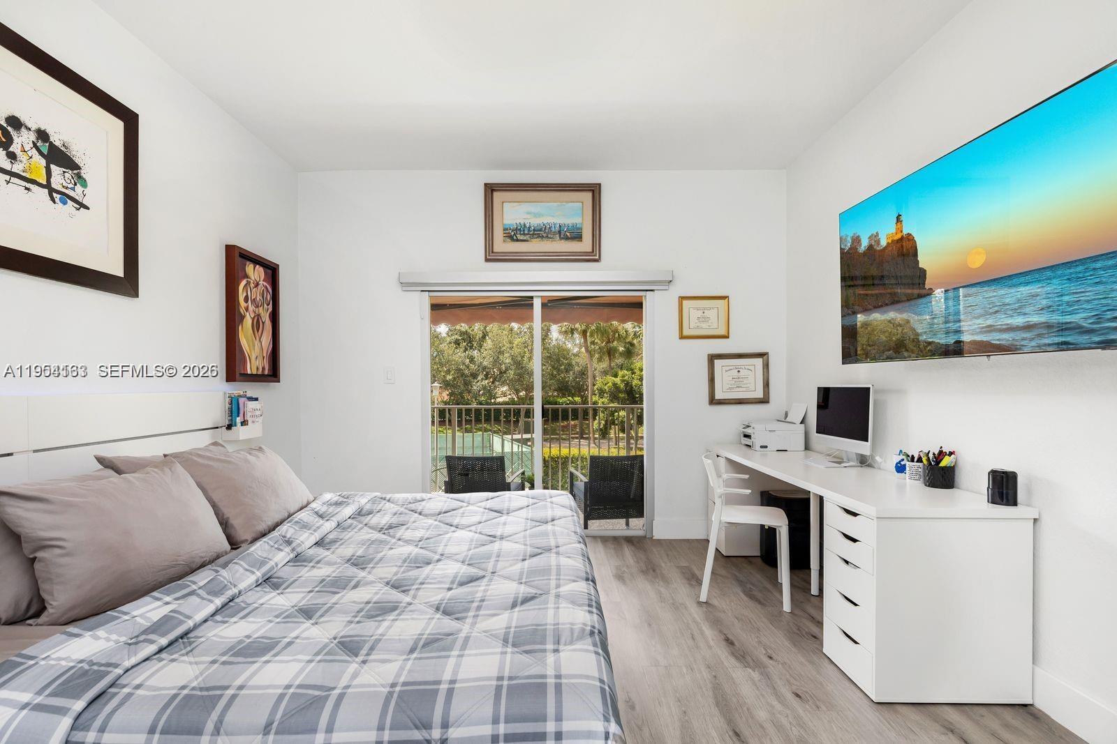 13216 Southwest 44th Street, Unit 11204 Miramar, FL 33027 - Photo 23 of 47 a bedroom with a bed and a flat screen tv