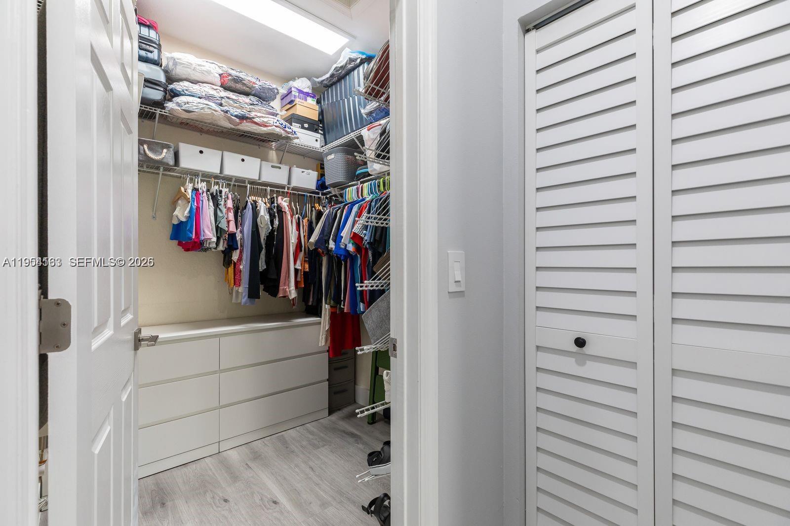 13216 Southwest 44th Street, Unit 11204 Miramar, FL 33027 - Photo 29 of 47 a view of walk in closet with clothes and shoes