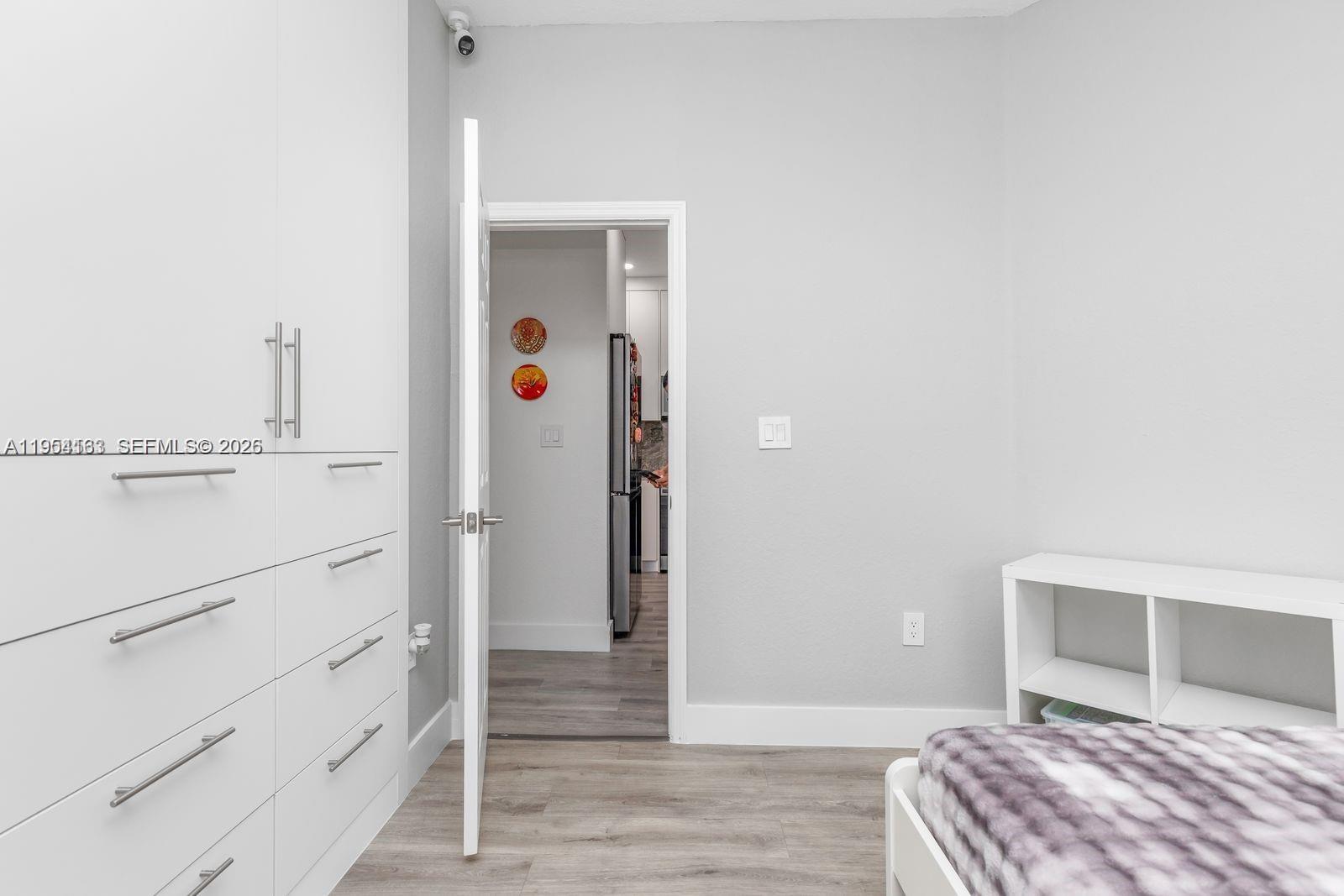 13216 Southwest 44th Street, Unit 11204 Miramar, FL 33027 - Photo 31 of 47 a bedroom with a bed and cabinets