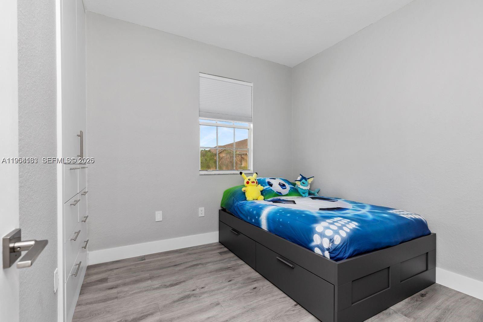 13216 Southwest 44th Street, Unit 11204 Miramar, FL 33027 - Photo 34 of 47 a bedroom with bed and window