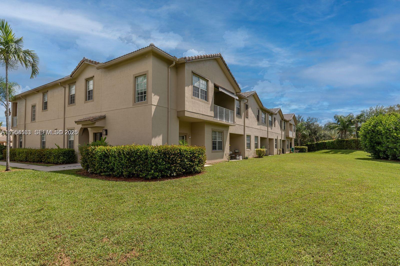 13216 Southwest 44th Street, Unit 11204 Miramar, FL 33027 - Photo 45 of 47 a front view of a house with a garden