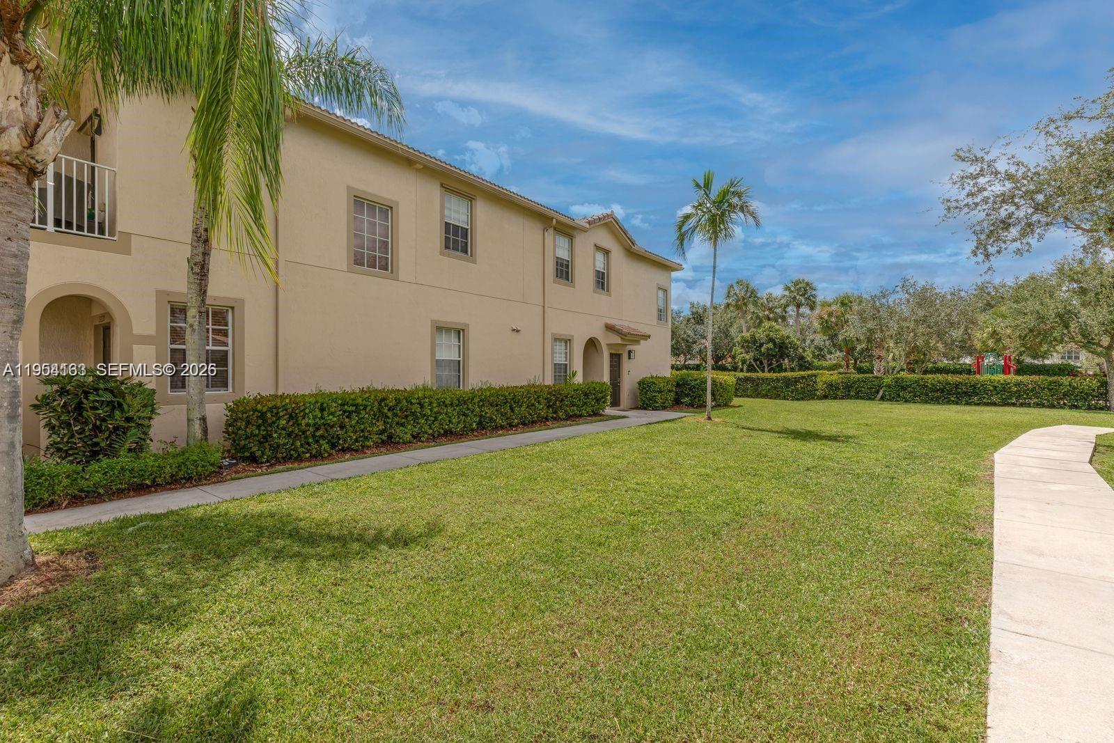 13216 Southwest 44th Street, Unit 11204 Miramar, FL 33027 - Photo 47 of 47 a front view of a house with garden