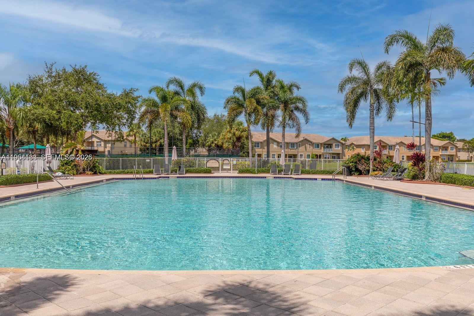 13216 Southwest 44th Street, Unit 11204 Miramar, FL 33027 - Photo 5 of 47 a backyard of a house with palm trees