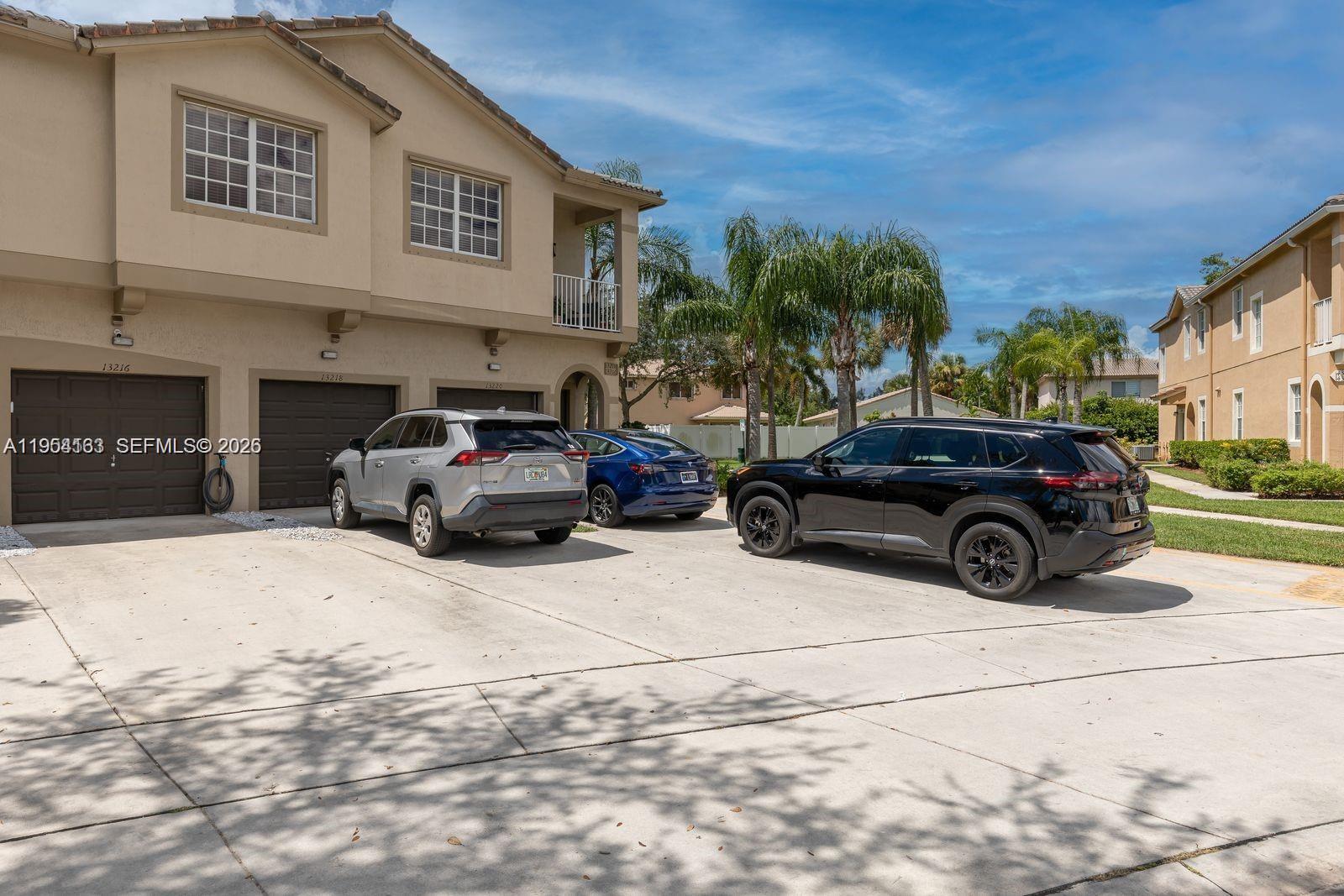 13216 Southwest 44th Street, Unit 11204 Miramar, FL 33027 - Photo 8 of 47 a car parked in front of a house
