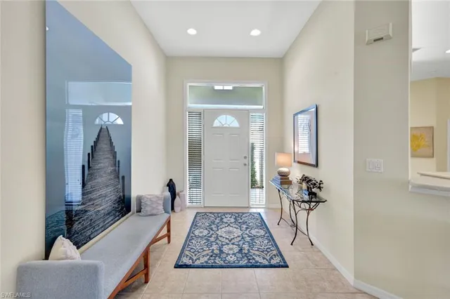 a view of a hallway with a livingroom and fireplace