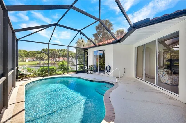 a view of a livingroom with furniture and floor to ceiling window