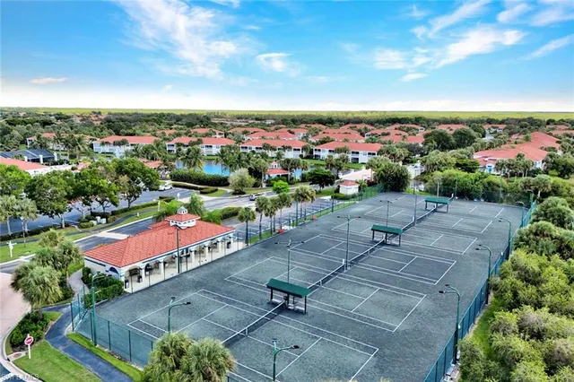 an aerial view of a tennis ground and a yard