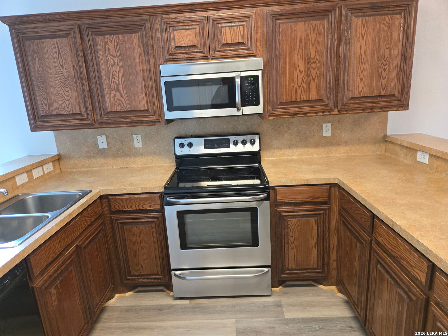 405 Point Valley San Antonio, TX 78253 - Photo 14 of 16 a kitchen with granite countertop a stove microwave and sink