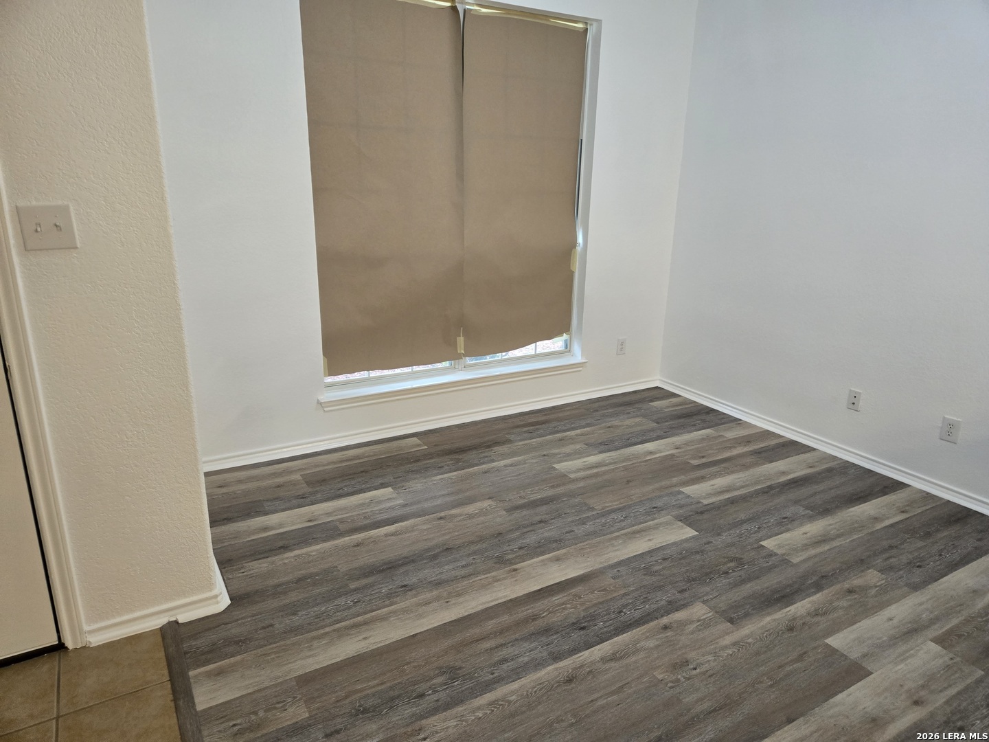 405 Point Valley San Antonio, TX 78253 - Photo 2 of 16 a view of an empty room with wooden floor and a window