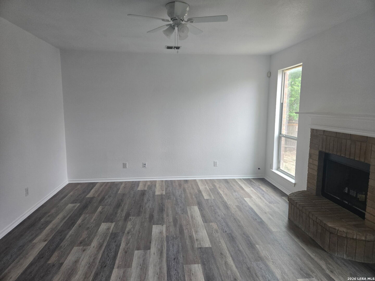 405 Point Valley San Antonio, TX 78253 - Photo 5 of 16 an empty room with wooden floor fireplace and windows