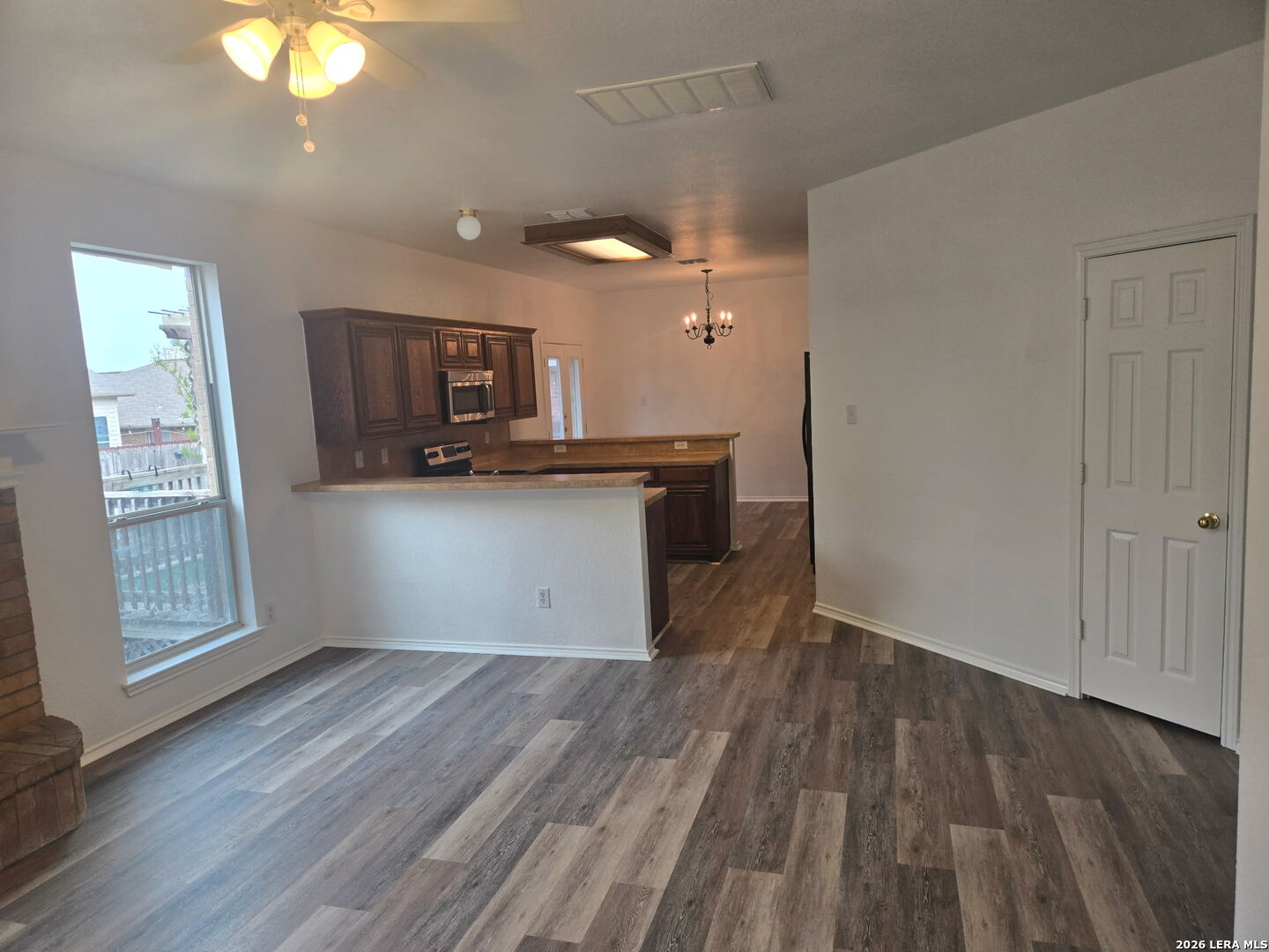 405 Point Valley San Antonio, TX 78253 - Photo 7 of 16 a kitchen with granite countertop a stove and a wooden floors
