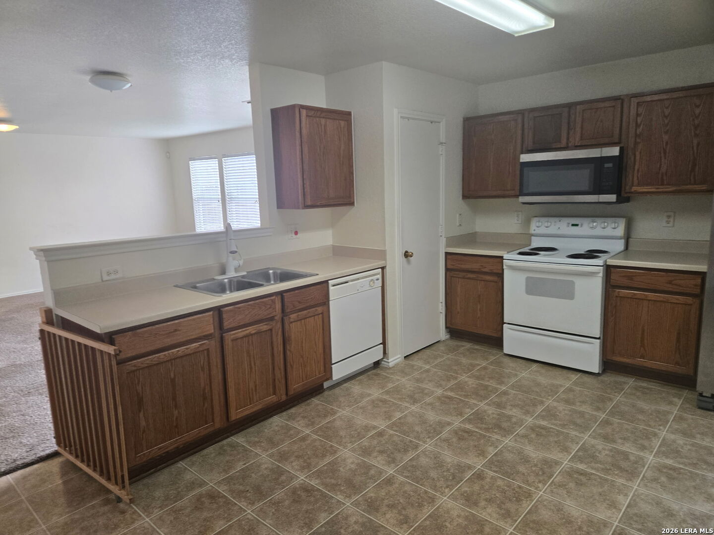 405 Point Valley San Antonio, TX 78253 - Photo 10 of 16 a kitchen with stainless steel appliances granite countertop a sink stove and microwave